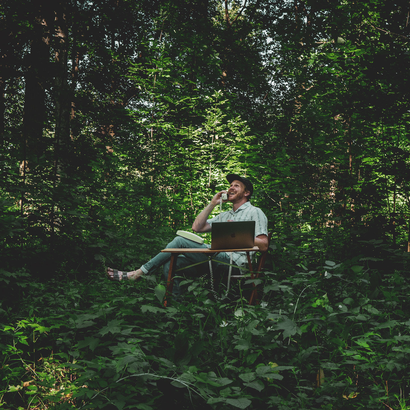 Jesse talking to clients in the woods on a phone